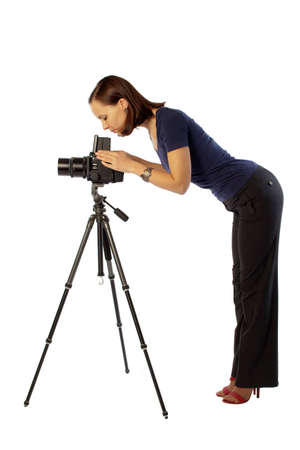 photo of beautiful girl  working with big camera mounted on tripod. Isolation on the whiteの写真素材