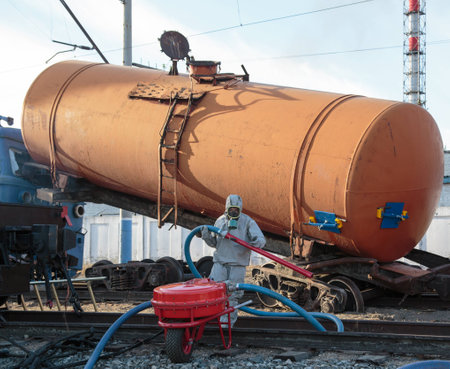 photo of rescuers training. They are trying to patch holes in tank with potentially dangerous liquids.の写真素材