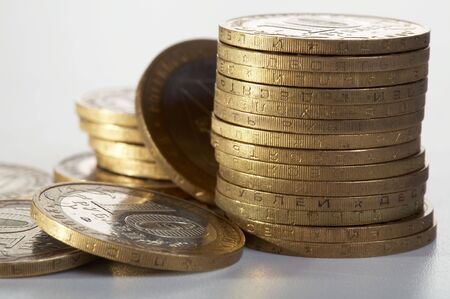 Yellow coins on a white backgroundの写真素材