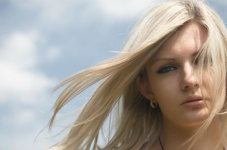 beautiful girl on a background of the blue skyの写真素材