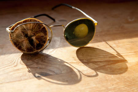 Old glasses with a dry lemon and reflection freshの写真素材