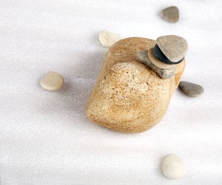 Pile of stones and the scattered pebble on a brilliant background