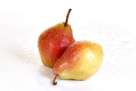 Pears with drops of water on a wet surfaceの写真素材