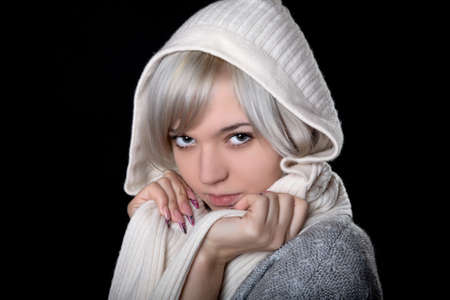 The girl in  white hood on a black backgroundの写真素材