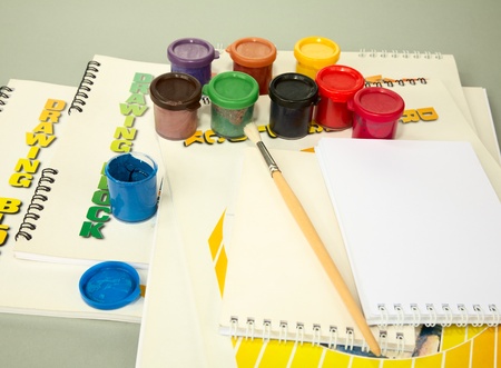 Albums for drawing and a paint on  grey background