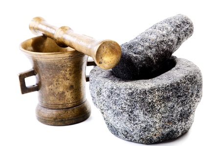 Granite and brass mortar with pestles on a white background