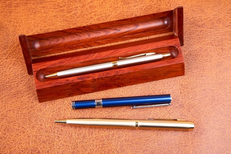 Three pens on a textural background