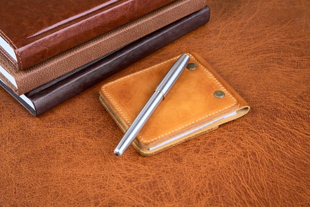 Business  still-life with leather organizers and a penの写真素材
