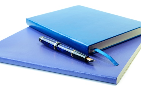 Dark blue writing-books and fountain pen isolated on a white backgroundの写真素材