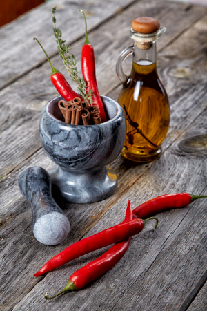 Still-life of spice and mortar on a old wooden tableの写真素材