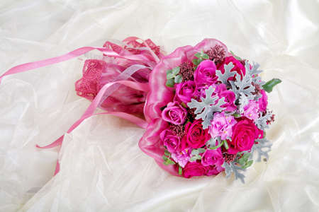 Purple wedding bouquet on a brilliant fabricの写真素材