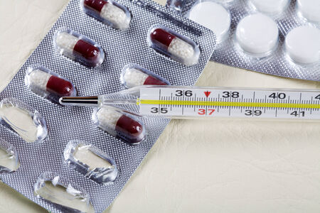 The medical thermometer and medicines in tabletsの写真素材