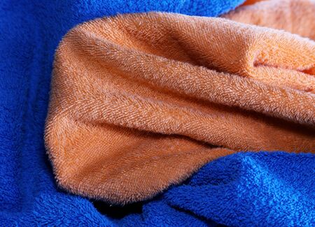 Dark blue and orange fabric with fibres a background