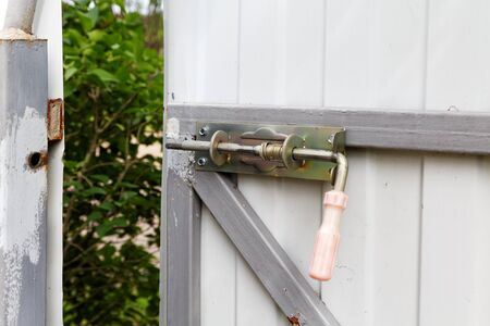 locking bolt on an iron fence