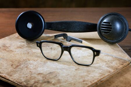 Old writing-books and glasses on a wooden table