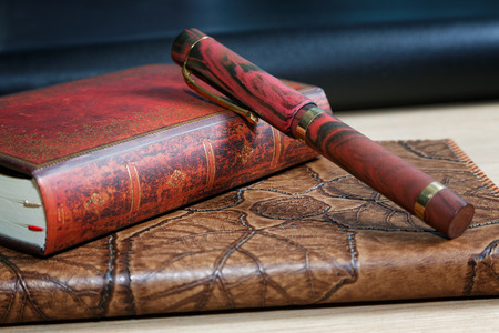 notebooks with leather cover pen  on the table