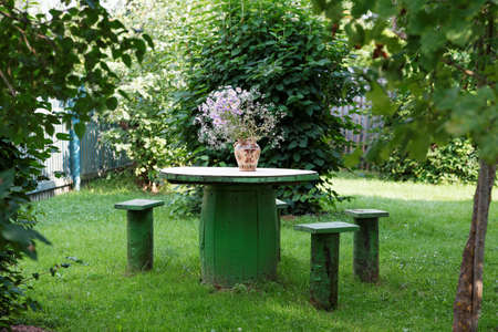 vase of flowers on a table in the gardenの写真素材
