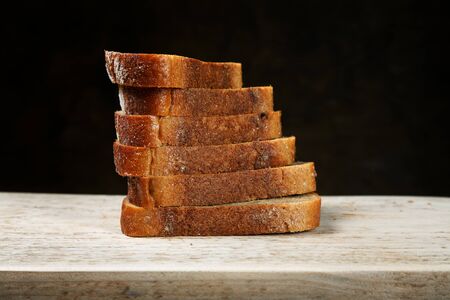 Sliced bread on a cutting boardの写真素材