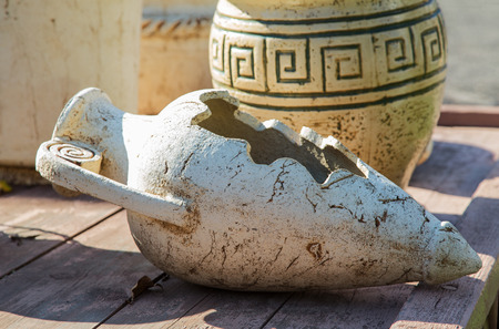 old clay jugs on a wooden table close-upの写真素材