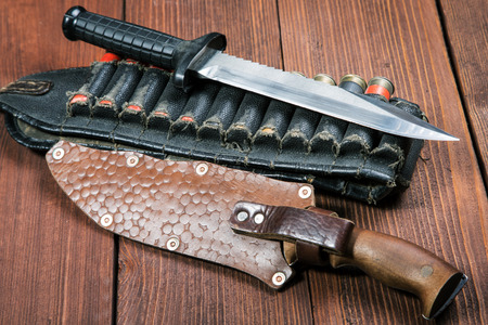 still life with a knife and bandolier on a close-up tableの写真素材
