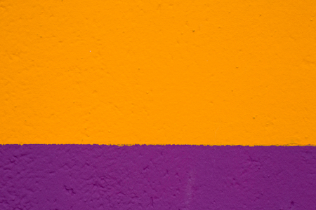 texture painted wall in yellow and purple colorの写真素材