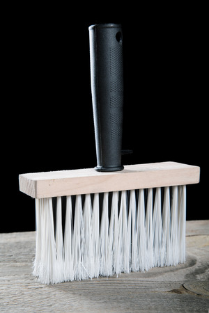 Paint brushes on a wooden table and a black backgroundの写真素材