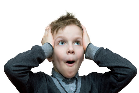 the boy with a surprised look clutched at his head. Isolated on white background