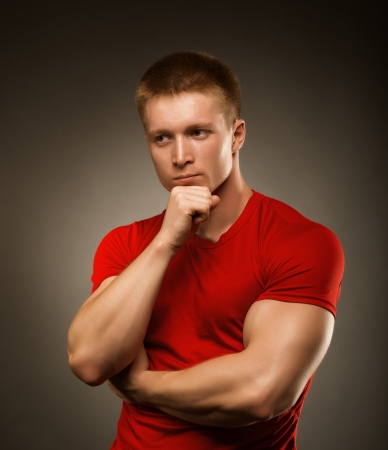 Healthy muscular young man  posing in studioの写真素材