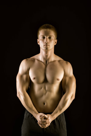 Healthy muscular young man  posing in studioの写真素材
