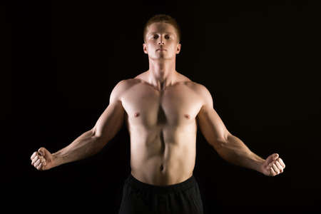 Healthy muscular young man  posing in studio