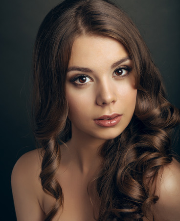 Portrait of a young beautiful brunette girl with long  hairの写真素材