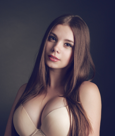 Portrait of a young beautiful brunette girl with long  hairの写真素材