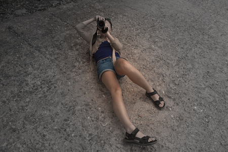 Young woman takes a photo. The creative process of photographingの写真素材