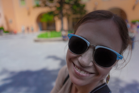 Young woman in the sunglasses and in excellent spirits.の写真素材