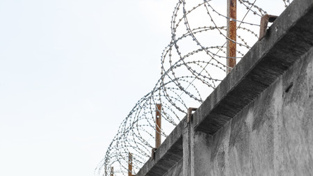 Concrete fence with a barbed wireの写真素材