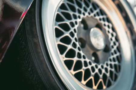 a shiny disc, cast in one piece from a light alloy of metals, a wheel of a car of old times. Close...