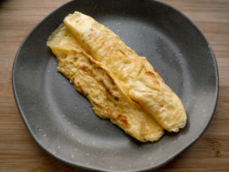 steamed omelet. on a plate on a gray background. view from above. vegetarian breakfast. healthy food conceptの写真素材