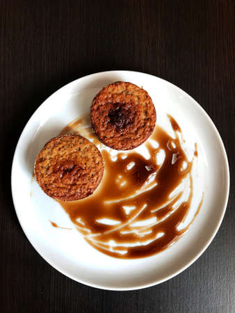 freshly baked chocolate cupcakes on a white plate.の写真素材