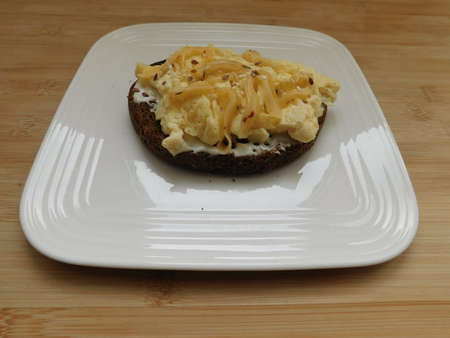 Scrambled Eggs on toasted bread for healthy breakfast or brunch, top view, copy space. Homemade meal...