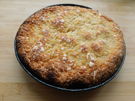 Freshly baked hot apple pie on wooden table