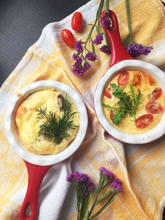 Traditional egg frittata with tomatoes and cheese in the oven Dish, Top View. Baked omelet with vegetables and cheeseの写真素材