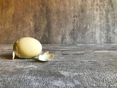 Hard boiled eggs with shell peeled on wooden table