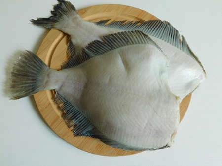 two fresh flounders, large and small, before cooking