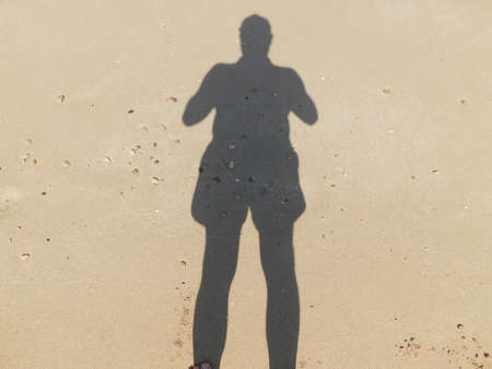 the shadow of a man on the sand, on the beach. cyprus.