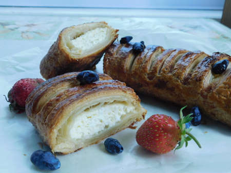 homemade puff pastry strudel with cottage cheese, wild berries and strawberries