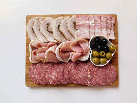 Antipasti and catering platter with different meat and cheese productsの写真素材