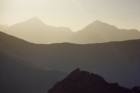 background layered mountain peaks at sunset