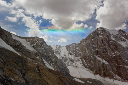 unusual beautiful rainbow above the snowy mountainsの写真素材