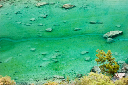 deep green mountain lake and tree above itの写真素材