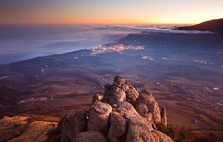 aerial view of luminous  city Yalta and sea from the mountains Demergi at sunset